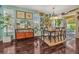 Bright dining area with hardwood floors, unique wall decorations, and a dining table at 14025 Oasis Springs Ln # 901, Windermere, FL 34786