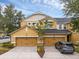 Charming townhouse with two-car garage and beautifully landscaped front yard under a blue sky at 14025 Oasis Springs Ln # 901, Windermere, FL 34786