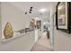Hallway decorated with decorative furniture and artwork, leads to a seating area at 14025 Oasis Springs Ln # 901, Windermere, FL 34786