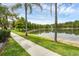 Scenic lake view from a walking path, showcasing the natural beauty of the community at 14025 Oasis Springs Ln # 901, Windermere, FL 34786