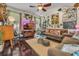 Cozy living room featuring hardwood floors, comfortable seating, and eclectic decor throughout at 14025 Oasis Springs Ln # 901, Windermere, FL 34786