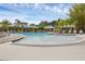 Large community pool surrounded by ample seating, palm trees, and resort-style amenities for outdoor enjoyment at 14025 Oasis Springs Ln # 901, Windermere, FL 34786