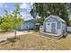 The property includes a shed with a porch, complemented by a lush, green lawn at 1432 Selma Ave, Orlando, FL 32825