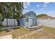 The shed features a quaint porch, nestled among mature trees in a well-maintained yard at 1432 Selma Ave, Orlando, FL 32825