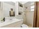 Bathroom with a white vanity, tiled shower, neutral decor, and ample storage at 1432 Selma Ave, Orlando, FL 32825