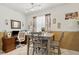 Bright dining area with a modern table, comfortable seating, and a home office setup at 1432 Selma Ave, Orlando, FL 32825