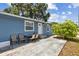 Inviting blue home with a charming front patio and lush landscaping, perfect for outdoor relaxation at 1432 Selma Ave, Orlando, FL 32825