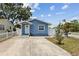 Charming blue single-story home featuring a well-manicured yard and a inviting front entrance at 1432 Selma Ave, Orlando, FL 32825