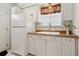 Bright kitchen featuring white cabinets, modern sink fixtures, and a view of the backyard at 1432 Selma Ave, Orlando, FL 32825