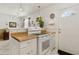 Cozy kitchen features white cabinets, tile floors, and stainless steel appliances near the entry door at 1432 Selma Ave, Orlando, FL 32825