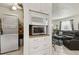 Laundry room features stacked washer/dryer units and an organized cabinet for cleaning supplies at 1432 Selma Ave, Orlando, FL 32825