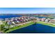 Beautiful aerial view of a lakeside home showcasing its well-manicured lawn and neighborhood amenities at 14753 Snowy Egret St, Winter Garden, FL 34787