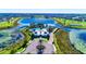 Aerial view of community pool and amenity center with winding walkways and lush landscaping at 14753 Snowy Egret St, Winter Garden, FL 34787