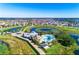An elevated view of a resort-style pool and clubhouse facility surrounded by tropical landscaping at 14753 Snowy Egret St, Winter Garden, FL 34787