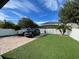 A fenced backyard features a brick drive, manicured lawn and green spaces at 14753 Snowy Egret St, Winter Garden, FL 34787