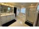Bright bathroom featuring double sink vanity, soaking tub with tile surround and separate glass-enclosed shower at 14753 Snowy Egret St, Winter Garden, FL 34787