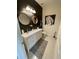 A bathroom with double vanity, granite countertops, a decorative mirror, and stylish decor at 14753 Snowy Egret St, Winter Garden, FL 34787