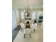 Modern dining area with a glass table, stylish chairs, and contemporary lighting at 14753 Snowy Egret St, Winter Garden, FL 34787