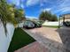 A brick driveway leads to a home with a manicured lawn, green spaces and white vinyl fence at 14753 Snowy Egret St, Winter Garden, FL 34787