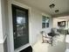 Inviting front porch with seating and a decorative front door at 14753 Snowy Egret St, Winter Garden, FL 34787