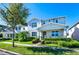Charming two-story home featuring mature landscaping and a well-maintained lawn on a sunny day at 14753 Snowy Egret St, Winter Garden, FL 34787