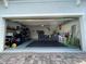 A spacious garage with storage shelving, a clean floor, and ample room for parking at 14753 Snowy Egret St, Winter Garden, FL 34787