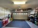 Clean, organized garage featuring a black work out mat and overhead storage at 14753 Snowy Egret St, Winter Garden, FL 34787
