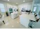 Bright kitchen with white cabinets, modern appliances, island with seating, and tile flooring at 14753 Snowy Egret St, Winter Garden, FL 34787