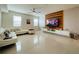 Bright living room featuring a wood accent wall, modern furniture, and ample natural light at 14753 Snowy Egret St, Winter Garden, FL 34787