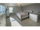 Spacious main bedroom with elegant decor, featuring tile floors, a ceiling fan, and ample closet space at 14753 Snowy Egret St, Winter Garden, FL 34787