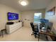 Bright home office with two monitors, sleek desk, and modern furnishings for a productive workspace at 14753 Snowy Egret St, Winter Garden, FL 34787