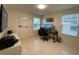 Dedicated home office space with dual monitors, desk, and ample natural light from two windows at 14753 Snowy Egret St, Winter Garden, FL 34787
