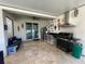 A covered outdoor kitchen features a built-in grill, stainless steel appliances, and a cozy seating area at 14753 Snowy Egret St, Winter Garden, FL 34787
