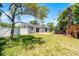 Spacious backyard featuring a well-maintained lawn, white fence, and above-ground pool perfect for outdoor enjoyment at 174 Pine Grove Ct, Daytona Beach, FL 32119
