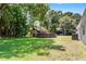 Expansive backyard with lush greenery features a treehouse with a slide, an above-ground pool, and ample space at 174 Pine Grove Ct, Daytona Beach, FL 32119