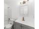 Bathroom with a vanity, toilet, mirror, and a shower-tub combination with white tile at 174 Pine Grove Ct, Daytona Beach, FL 32119