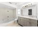 Modern bathroom with tub, tiled shower, vanity with double sinks, and stylish fixtures at 174 Pine Grove Ct, Daytona Beach, FL 32119