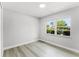 Cozy bedroom with durable laminate floors and a bright window at 174 Pine Grove Ct, Daytona Beach, FL 32119
