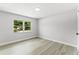 Bright bedroom featuring durable laminate floors and a large window for natural light at 174 Pine Grove Ct, Daytona Beach, FL 32119
