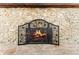 Close up of a decorative stone fireplace featuring an ornate metal fireplace screen at 174 Pine Grove Ct, Daytona Beach, FL 32119