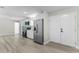 Modern kitchen featuring new stainless steel appliances, sleek countertops, and wood vinyl flooring at 174 Pine Grove Ct, Daytona Beach, FL 32119