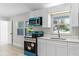 Bright kitchen featuring contemporary appliances, white cabinets, and a well-lit window for a pleasant cooking experience at 174 Pine Grove Ct, Daytona Beach, FL 32119
