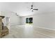 Spacious living room featuring modern vinyl floors, sliding glass doors and great backyard views at 174 Pine Grove Ct, Daytona Beach, FL 32119
