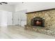 Spacious living room featuring tile floors, a stone fireplace, and easy access to other rooms at 174 Pine Grove Ct, Daytona Beach, FL 32119