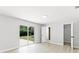 Main bedroom featuring laminate floors, an exterior door, and an ensuite bath at 174 Pine Grove Ct, Daytona Beach, FL 32119