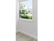 Cozy interior view through a window showing a lush green yard and bright sunlight streaming into the room at 174 Pine Grove Ct, Daytona Beach, FL 32119