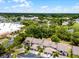 Aerial view of townhomes in a wooded community and easy access to nearby shopping at 179 Crown Point Cir, Longwood, FL 32779