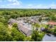Scenic aerial view of charming townhomes nestled within a lush, green, tree-filled community at 179 Crown Point Cir, Longwood, FL 32779
