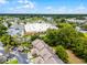 Aerial view of townhomes near commercial district with tree coverage and convenient parking at 179 Crown Point Cir, Longwood, FL 32779