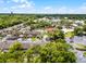 Aerial view of a community with a pool surrounded by lush trees and convenient parking at 179 Crown Point Cir, Longwood, FL 32779